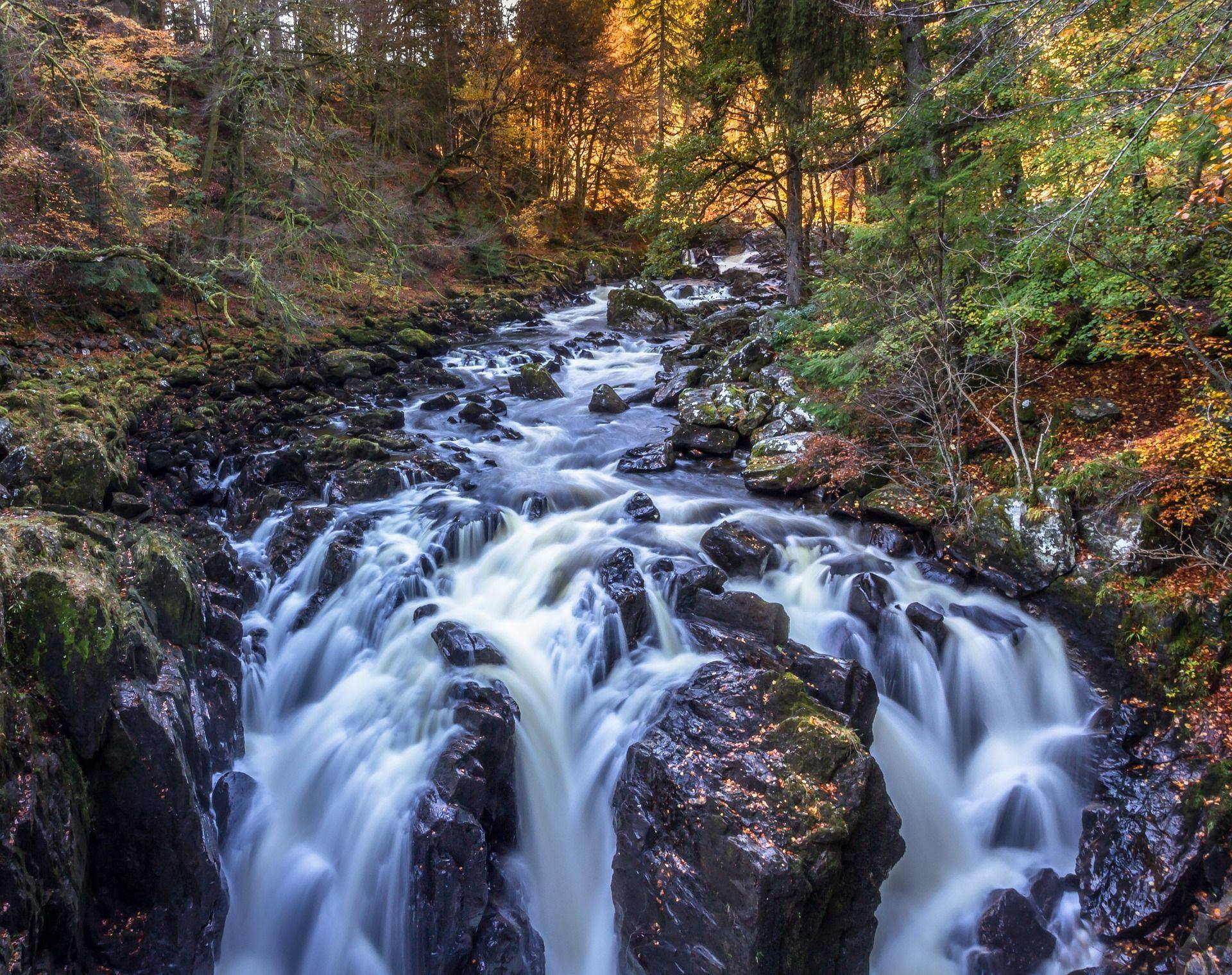 Waterfall over some rocks in a forest