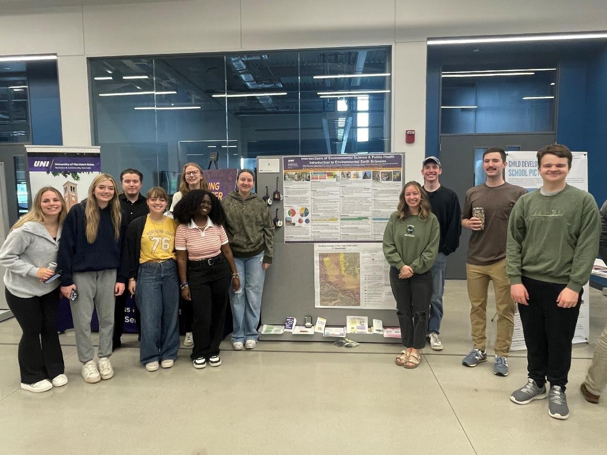Group of students standing in front of their poster