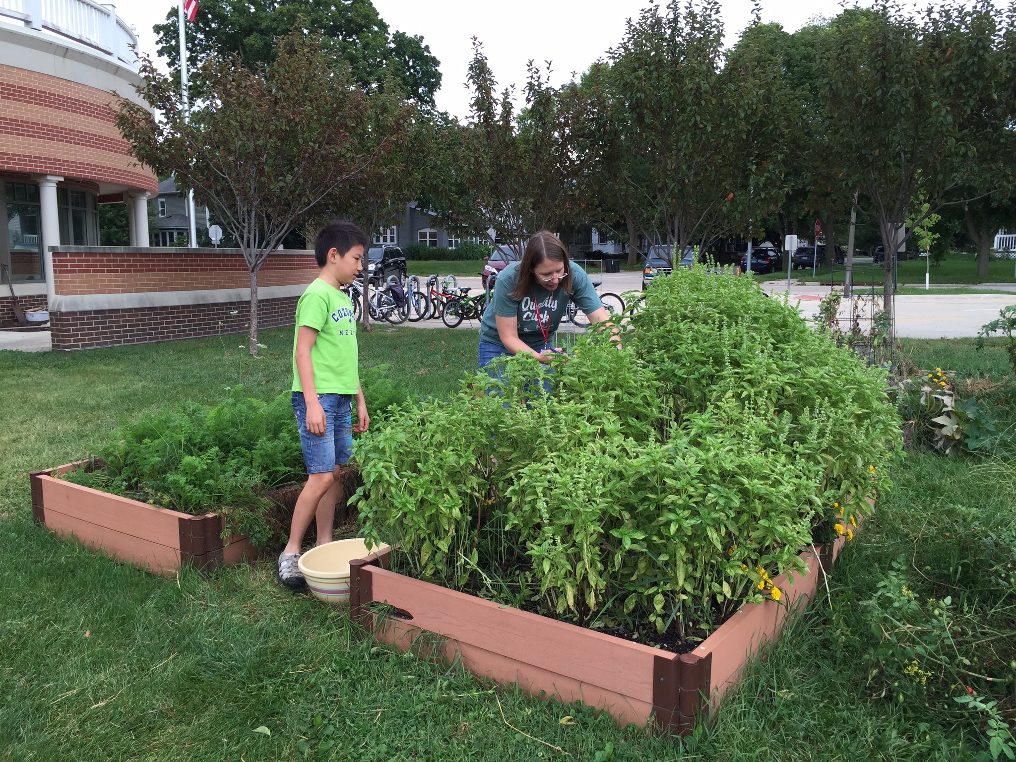 Two people gardening in a raised garden bed