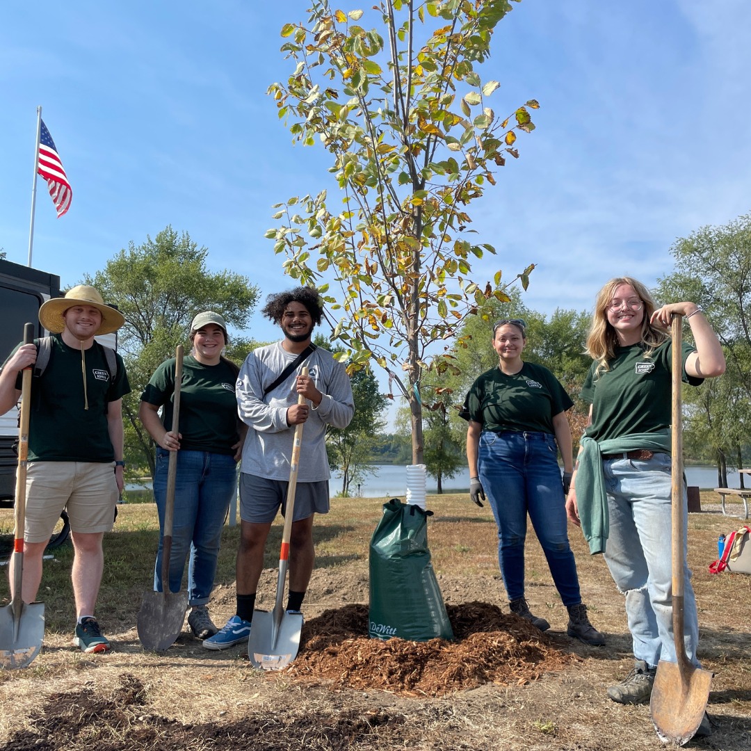 AmeriCorps members planting a tree