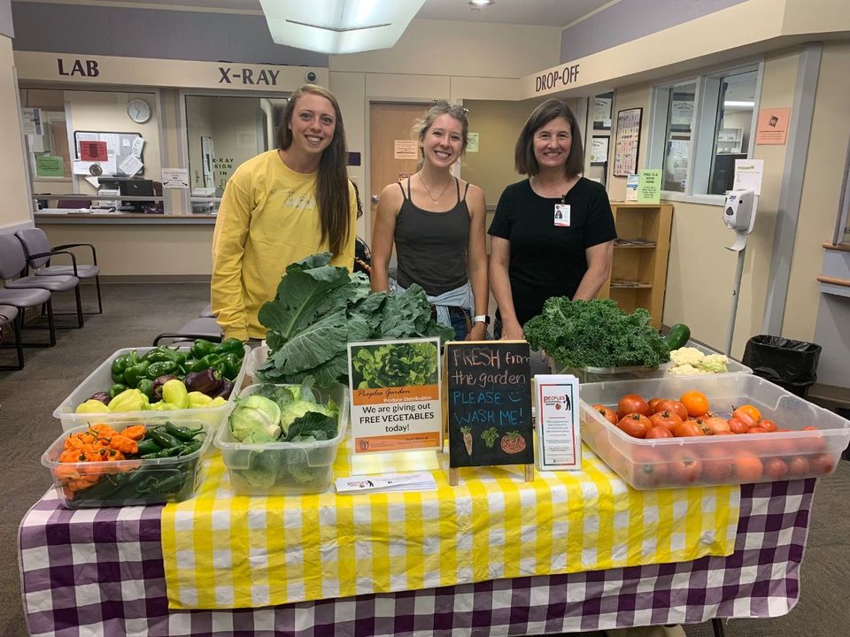 VISTA Members hosting a free veggie table at Peoples Community Health Clinic