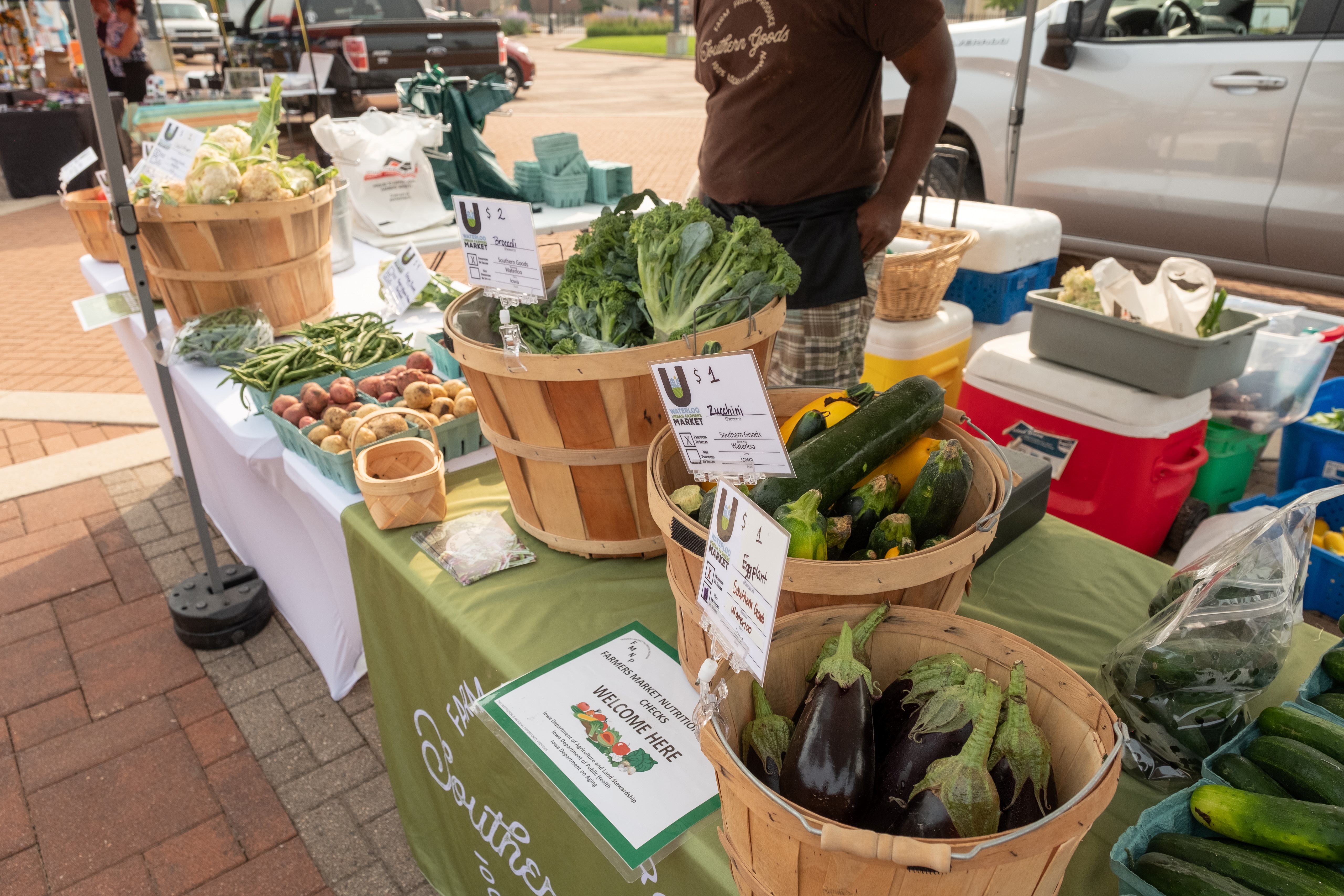 Farmers market stand with various vegetables laid out on the table